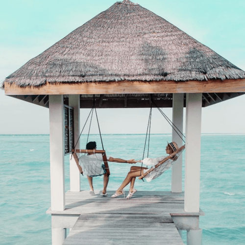 Woman and Man by Ocean in Cabana